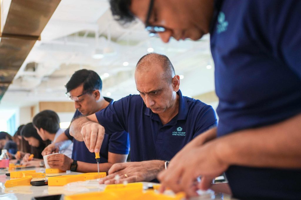 The office team making Solar Buddy lamps for disadvantaged children